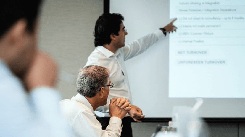 An illustration of a research paper being presented on a large screen at a conference.
